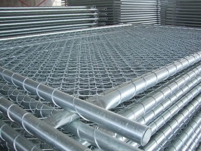 Many small size temporary chain link fence panels with the infilled woven mesh attached on the round tubes.
